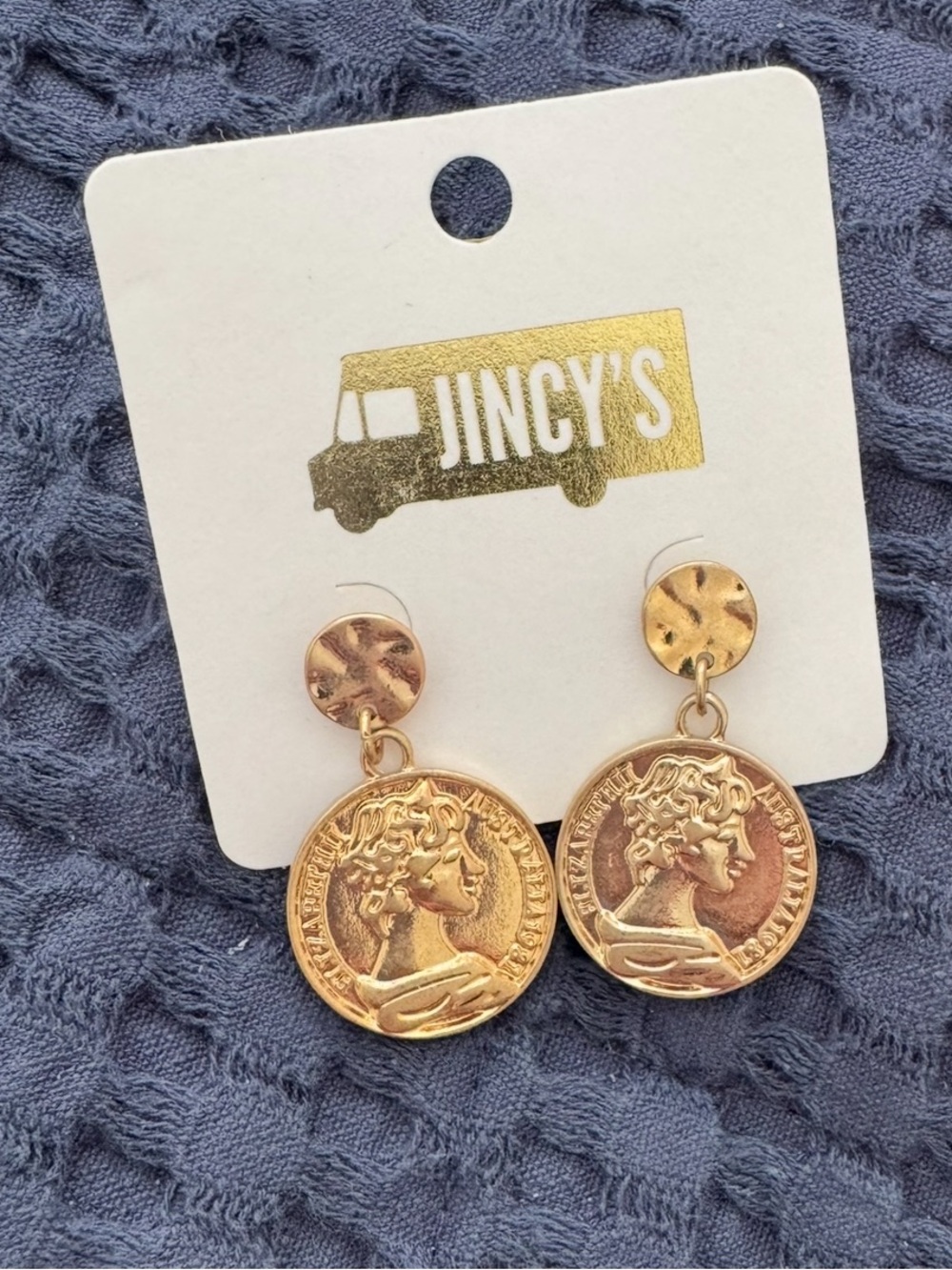 Jincy's gold-toned coin earrings with dangling 1981 Australian medallion charms.